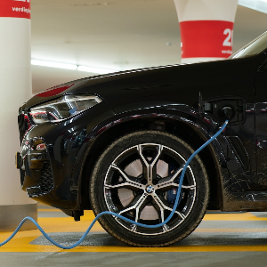 An electric vehicle plugged into a charger