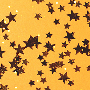 Gold star confetti on a yellow background