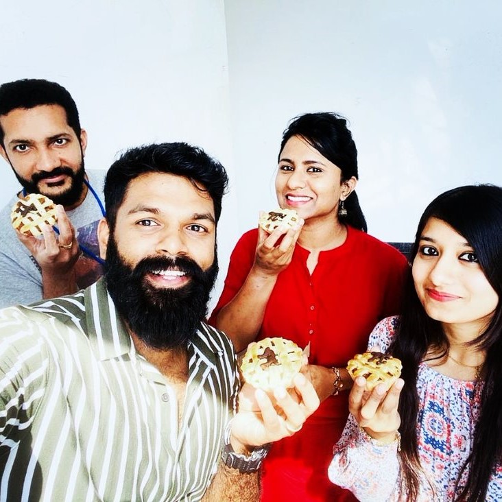 group of people holding piece of food
