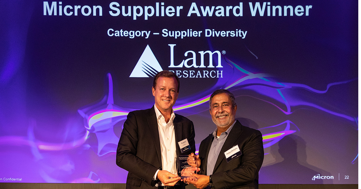 CEO of Lam Research accepts an award from Micron