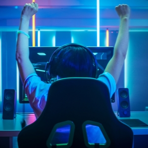person raising arms in front of game