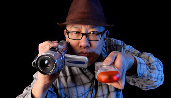 A man holding a video camera and a thermal imager.