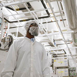 Man wearing a bunny suit in a clean room 